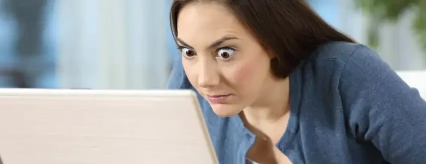 Woman absolutely shocked by laptop