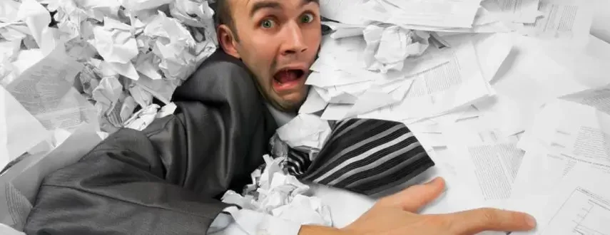 Man overwhelmed by paperwork, highlighting website copywriting services