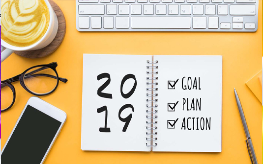 2019 written in an open notebook on a yellow background