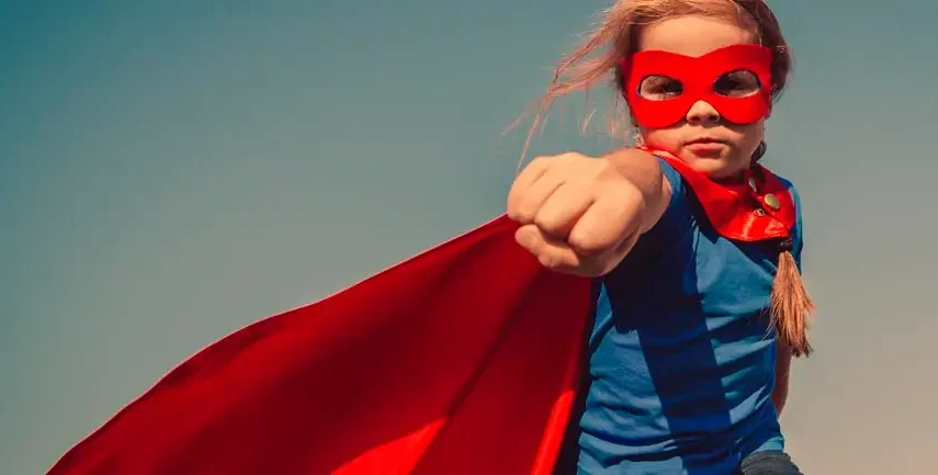 Girl dressed as a superhero posing