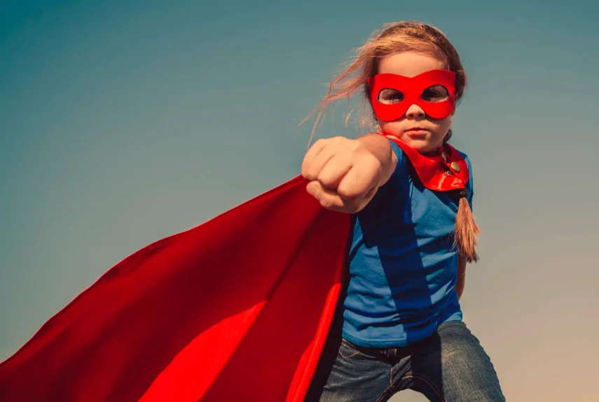 Girl dressed as a superhero posing