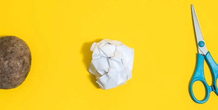 A rock, paper and a pair of scissors