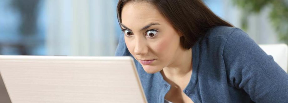 woman looking surprised at her work on computer