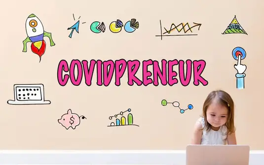 Toddler using laptop with COVIDPRENEUR graphic