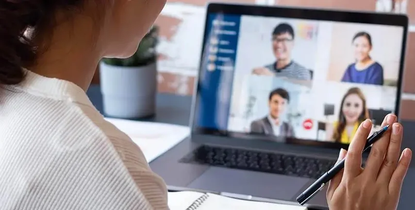 Woman on a Zoom call waving, used in digital marketing service Essex banner